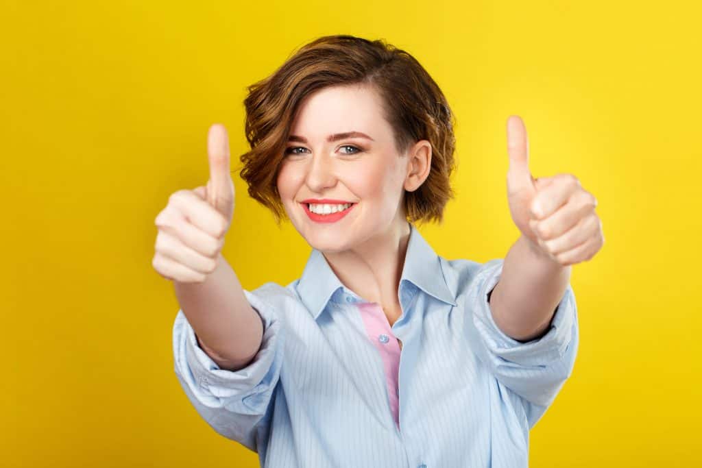 A woman making thumbs up