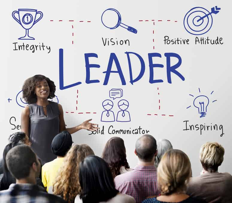 Woman standing in front of board that say leader