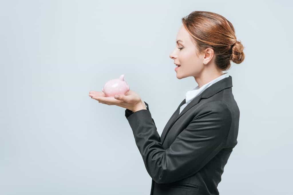 A female entrepreneur holding a piggy bank