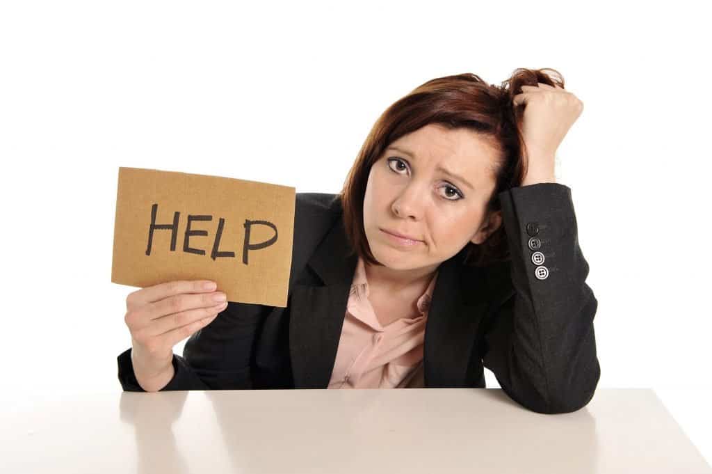 A female entrepreneur holding a signage that says HELP.