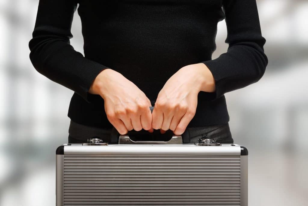 A women entrepreneur holding a briefcase.