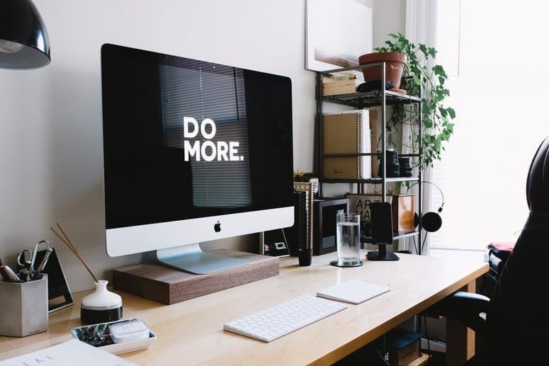 A desktop with keyboard and mouse under the table.